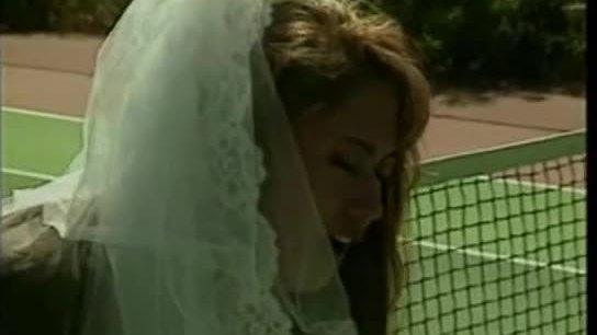 Asian bride on a tennis court